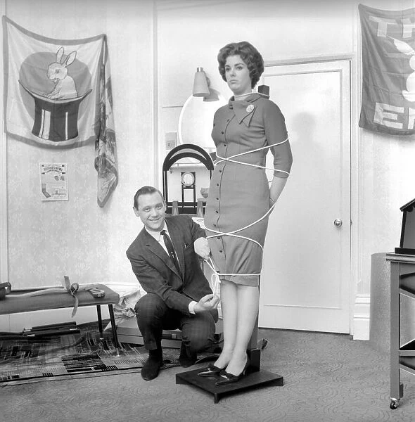 Magician Bernard Hughes performing rope trick with female assistant. April 1965 A1116b
