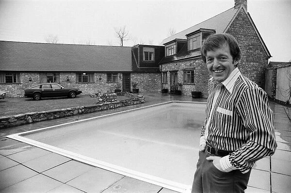 Magician Paul Daniels beside his swimming pool and house in Buckinghamshire
