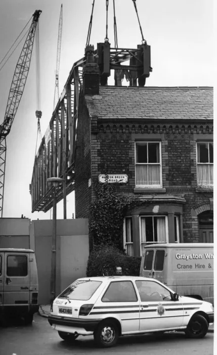 Framed Print : The main supporting girder for the new Kemlyn Road Stand is hoisted into place seen here Framed Print : The main supporting girder for the new Kemlyn Road Stand is hoisted into place seen here