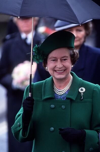 Her Majesty Queen Elizabeth II holds an umbrella during her visit to Torbay to celebrate