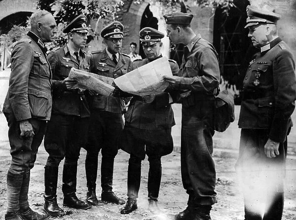 Major General Erich Elster, surrounded by his staff, discusses terms for his surrender