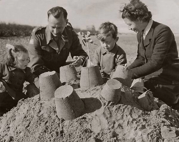 Major and Mrs Wright with sons Jack 2 and David 5 make sandcastles on beach April