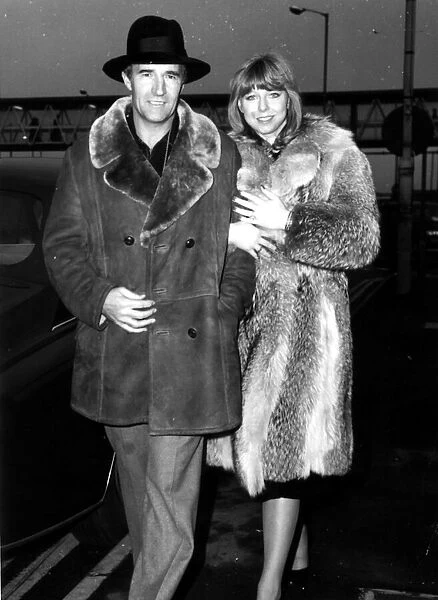 Malcolm Allison football manager seen here at Heathrow airport with partner