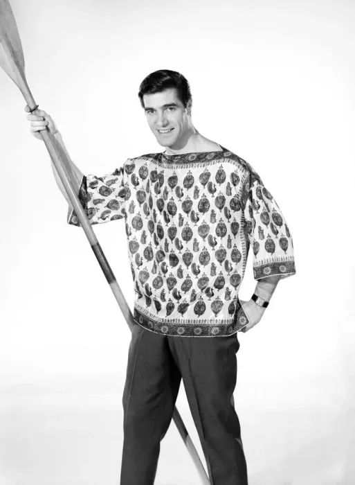 Framed Print : Male model Peter Christian wearing silk shirt seen here holding a oar. Circa 1964