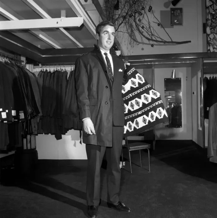 Framed Print : Male model wearing raincoat in menswear department. 1966