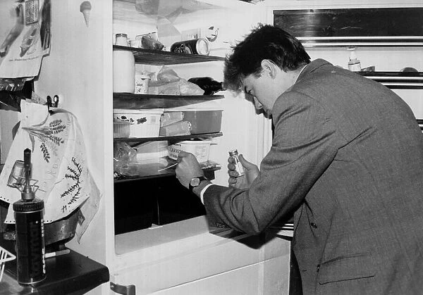 A man applies a swab test as he checks his fridge for bugs march 1991