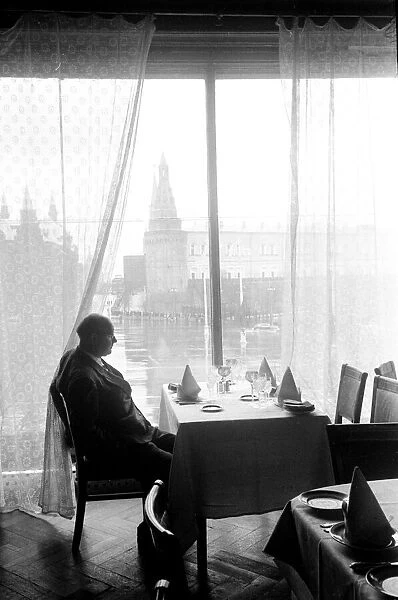 A man at at restaurant table over looking Red Square in Moscow, USSR