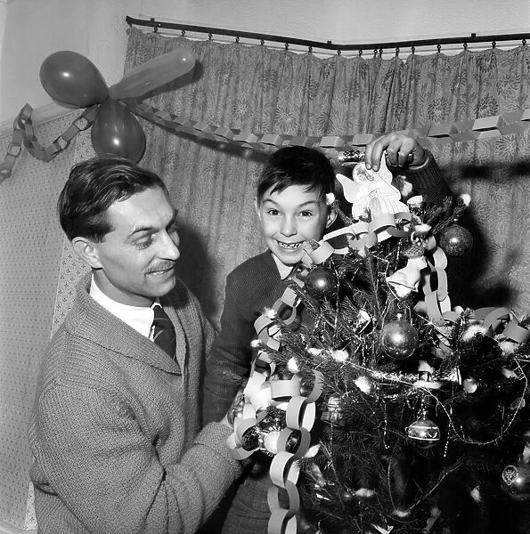 Man and boy dressing the christmas tree. Mr. Frederick Martin 44 Grey Tower Avenue