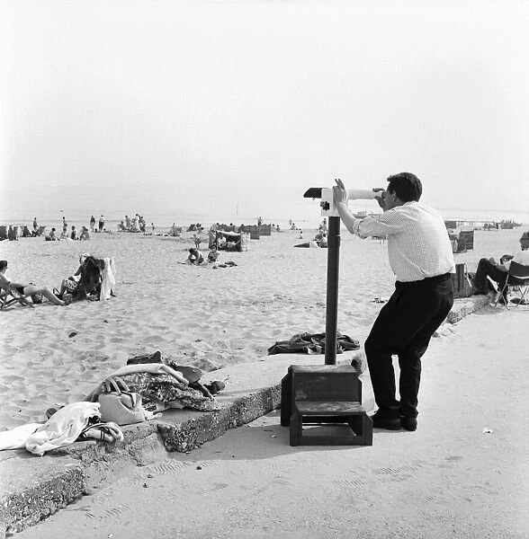 A man checking out the view across Sandbanks Beach in Poole, Dorset. June 1960 M4341