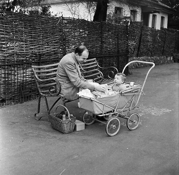 A man and child enjoying a picnic at London Zoo. 29th December 1954