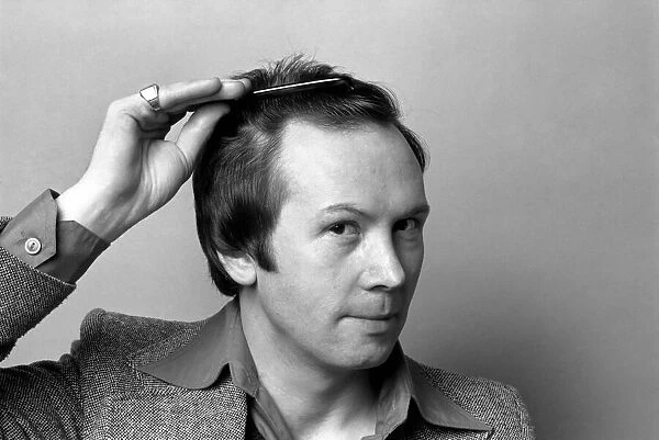 Man combing his hair. July 1975 75-00177-002