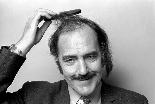 Man combing his hair. July 1975 75-00177