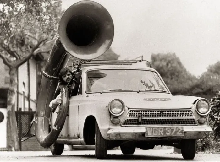 Framed Print : A man driving car with a large Sousaphone attached to the side Musical instruments Framed Print : A man driving car with a large Sousaphone attached to the side Musical instruments