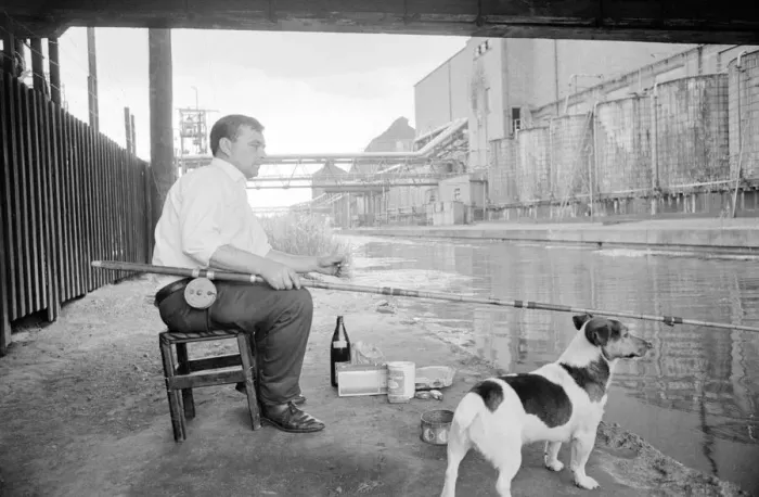 Framed Print : This man enjoys a smoke as he wait patiently for a bite Framed Print : This man enjoys a smoke as he wait patiently for a bite