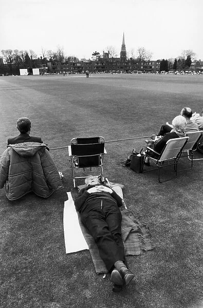 A man falls asleep on the boundary of the first cricket match of the season between