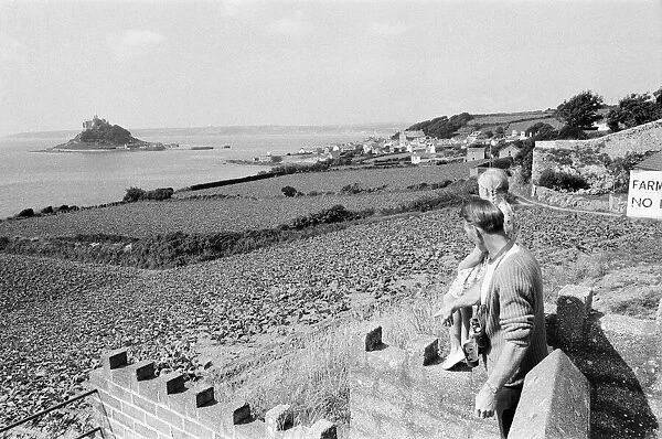 A man and girl looking out to St Michaels Mount, Cornwall, September 1968