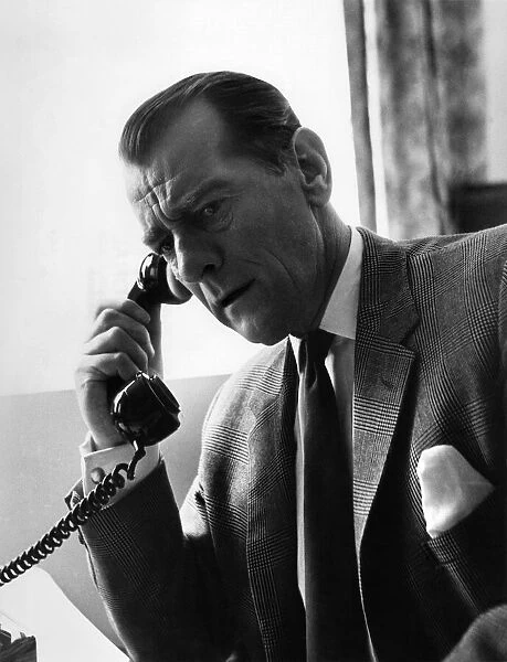 Man having a telephone conversation at his desk. Circa 1960 P009059