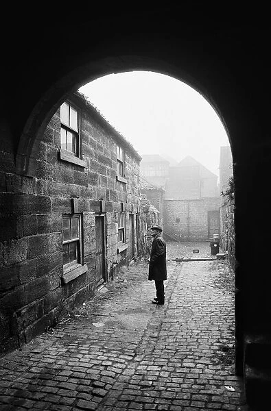 A man inspects a 16th century cottage in Guisborough. Redcar, Cleveland. Circa 1975