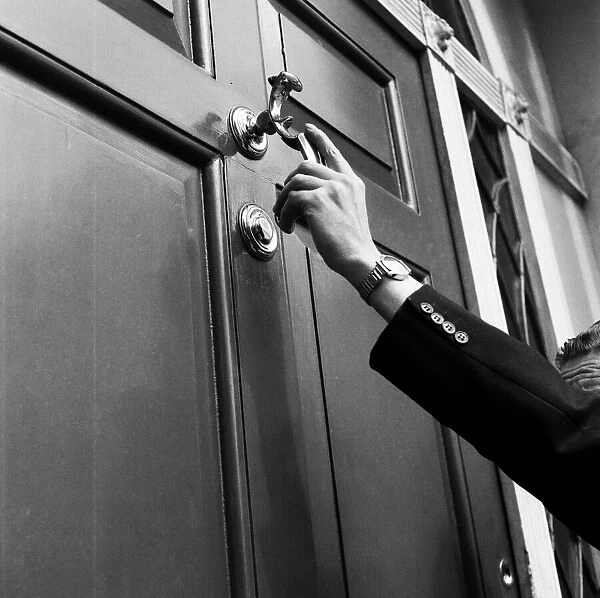 A man knocking on a door. September 1955