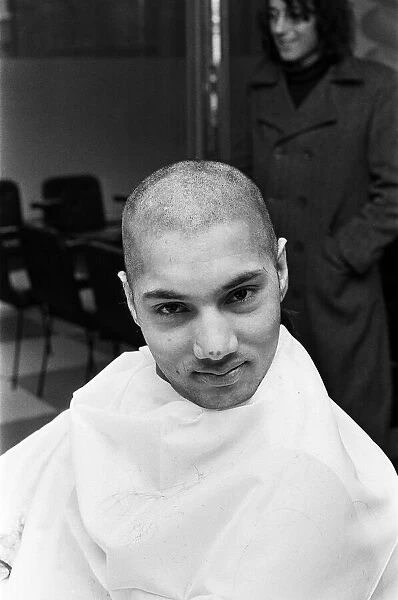 A man with a 'Kojak'hair cut. 1975