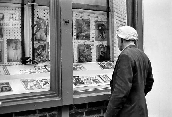 Man loooking in a book shop window in Soho. December 1970 70-11636-004