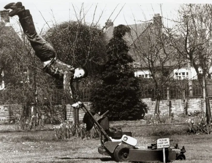 Framed Print : A man mowing his lawn with doing a hand stand on the handles of an electrical lawn mower Framed Print : A man mowing his lawn with doing a hand stand on the handles of an electrical lawn mower