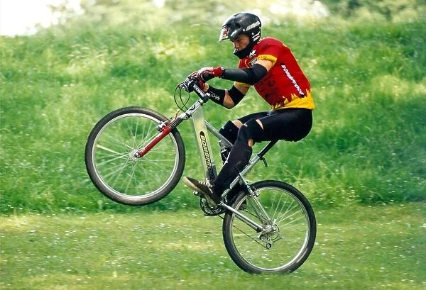 A man performing stunts on his BMX bike