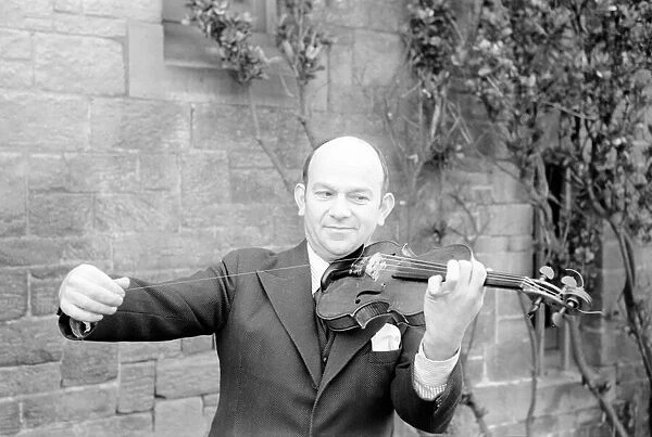 Man repairs strings on violin. January 1939 OL304G