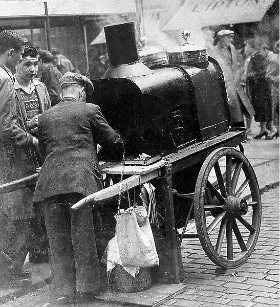 A man selling hot chesnuts on the Newcastle Streets c. 1955