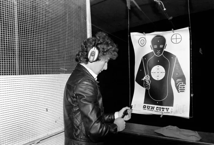 Framed Print : A man shooting at a target during practice at Gun City shooting range in South Africa Framed Print : A man shooting at a target during practice at Gun City shooting range in South Africa