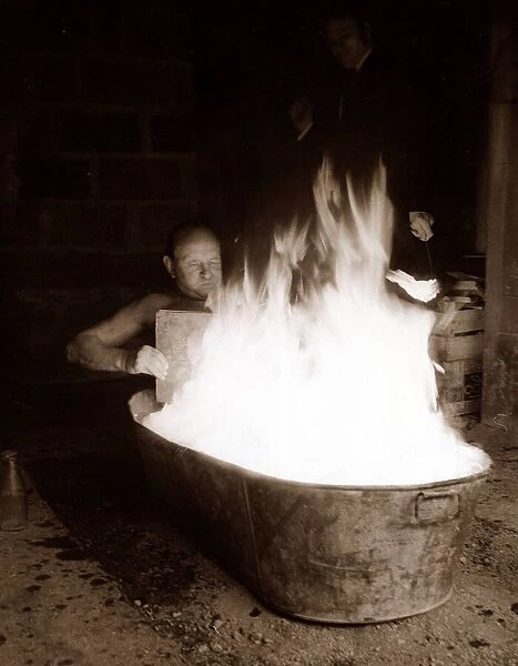 man sitting in Tub of Flames - man having a bath March 1969