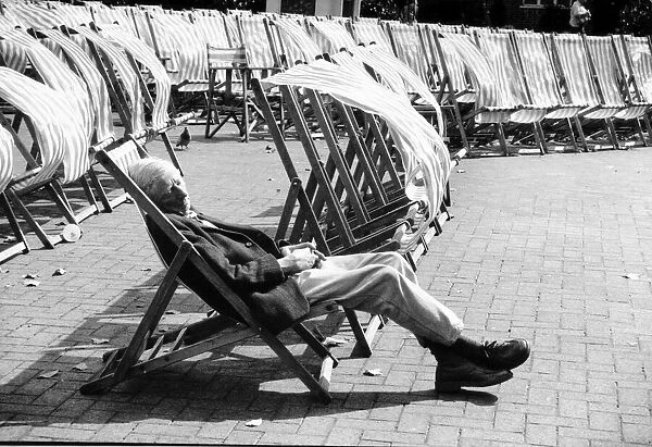 A man sleeps in a deckchair during windy weather at Brighton 31st August 1992