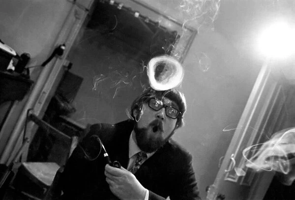 A man smoking a cigarette blowing smoke rings. November 1969 Z12004-005