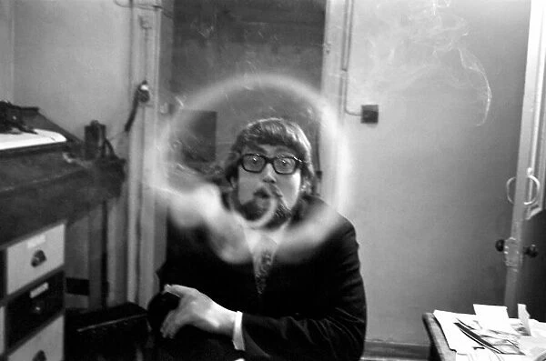 A man smoking a cigarette blowing smoke rings. November 1969 Z12004