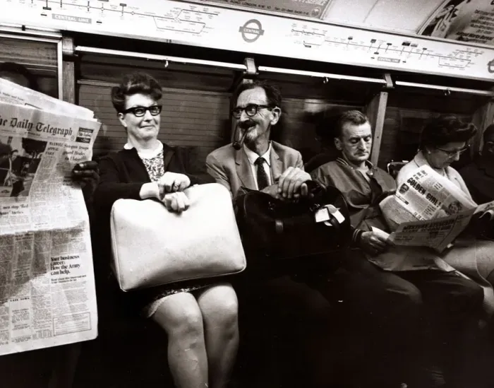 Framed Print : A man smoking a pipe pulls a funny face at his traveling companion. September 1969 Framed Print : A man smoking a pipe pulls a funny face at his traveling companion. September 1969