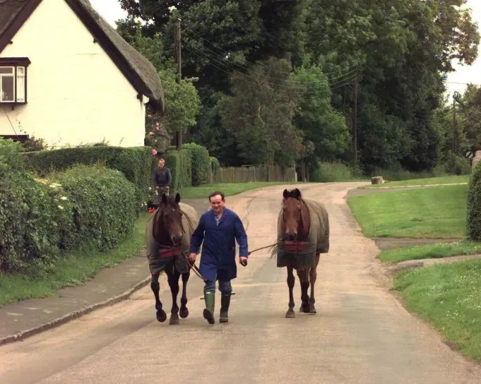Framed Print : Man walking horses through the village of Offchurch in Warwickshire