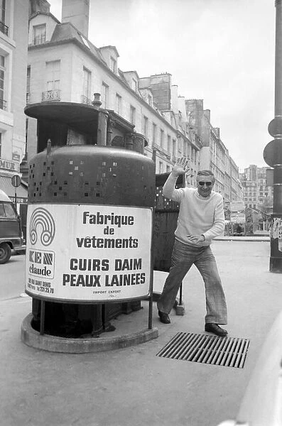 A man waves as he walks out of a public convenience in Paris