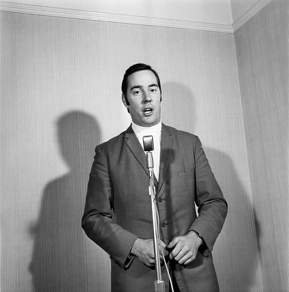 A man wearing a suit singing into a microphone. November 1969 Z10935-022