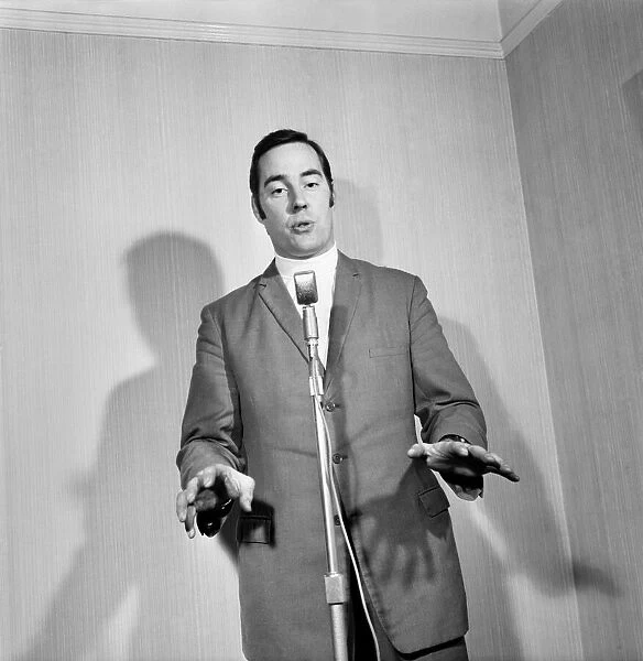 A man wearing a suit singing into a microphone. November 1969 Z10935-019