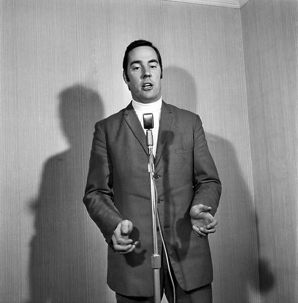 A man wearing a suit singing into a microphone. November 1969 Z10935-018