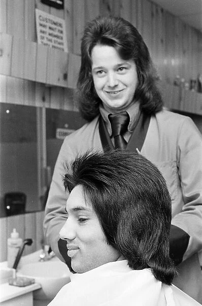 A man who is getting a 'Kojak'hair cut. 1975