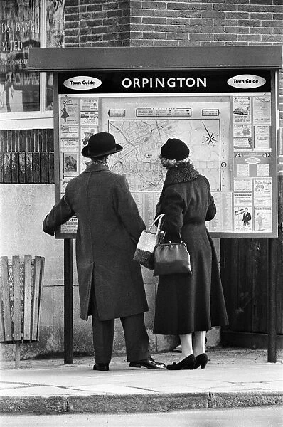 A man and woman looking at a map of Orpington, Orpington High Street, Kent