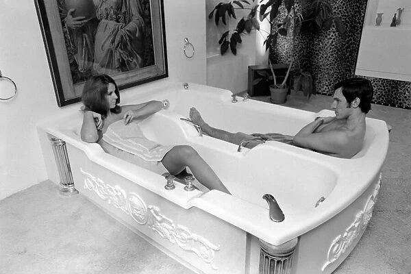 Man and woman sharing a bath designed for two. November 1969 Z10586-010