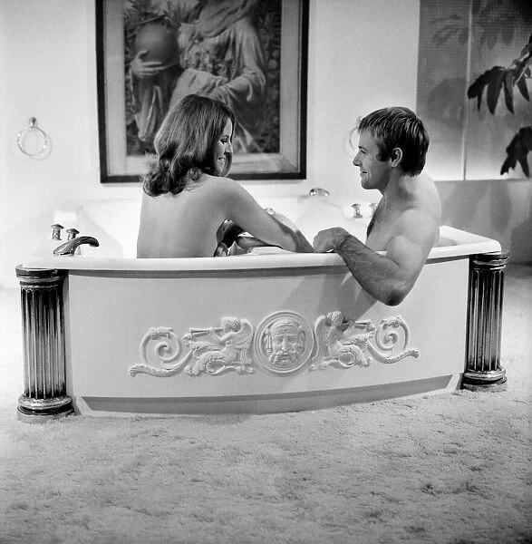 Man and woman sharing a bath designed for two. November 1969 Z10586-006
