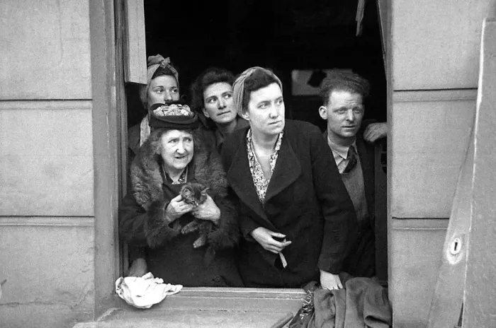 Framed Print : A man and four women with a kitten look out a window at the bomb damage in Kentish Town Framed Print : A man and four women with a kitten look out a window at the bomb damage in Kentish Town