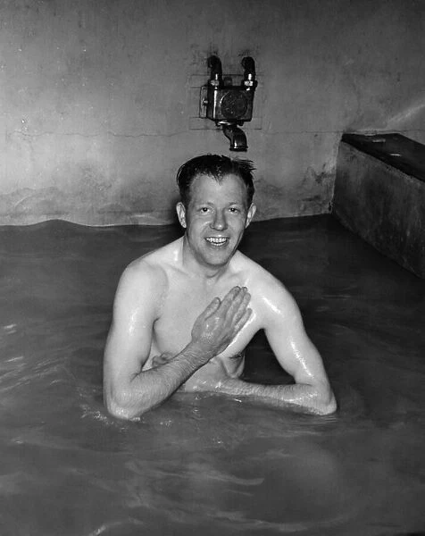 Manager Bert Flatley, ex-Buckley-boy, enjoys a bath after playing with the team in their