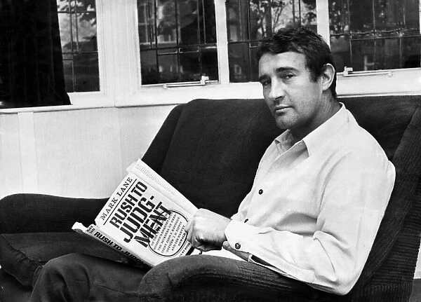 Manchester City assistant manager Malcolm Allison pictured at home reading his book '