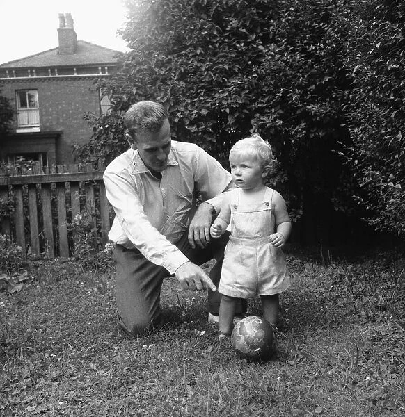 Manchester City footballer Don Revie pictured with his son Duncan in the back garden of