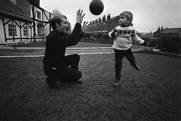 Manchester City footballer Francis Lee playing football with his son at home March