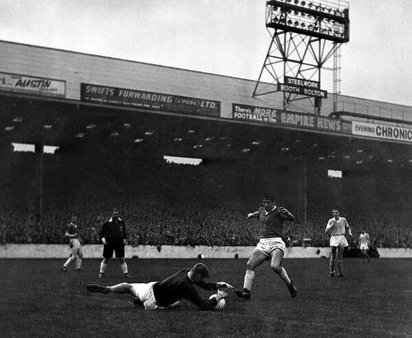 Manchester City goalkeeper Bert Trautmann dives and saves at the feet of Dawson of